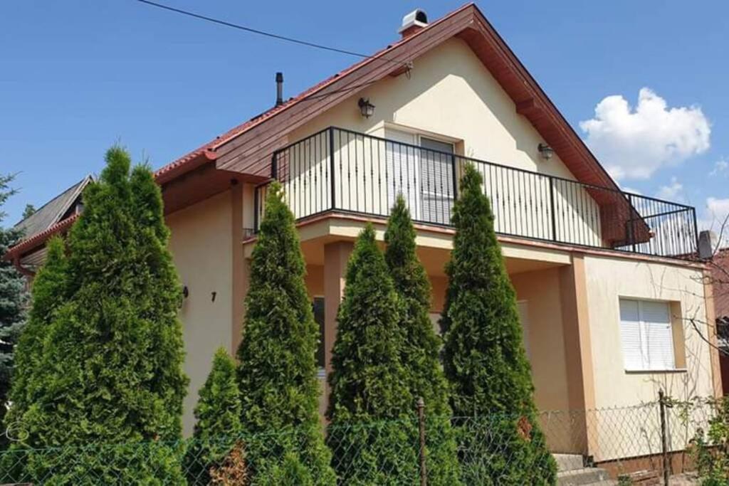 una casa con árboles delante de ella en Villa Tátika, en Gárdony