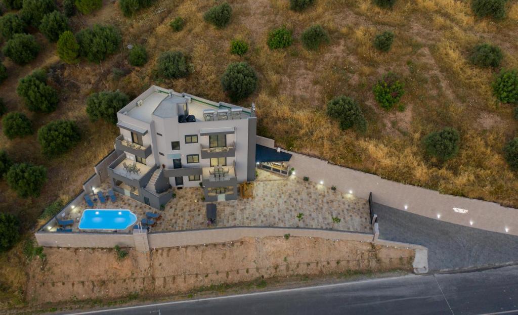 an aerial view of a house on a hill at Elmaky Luxury Apartments in Palaiokastro