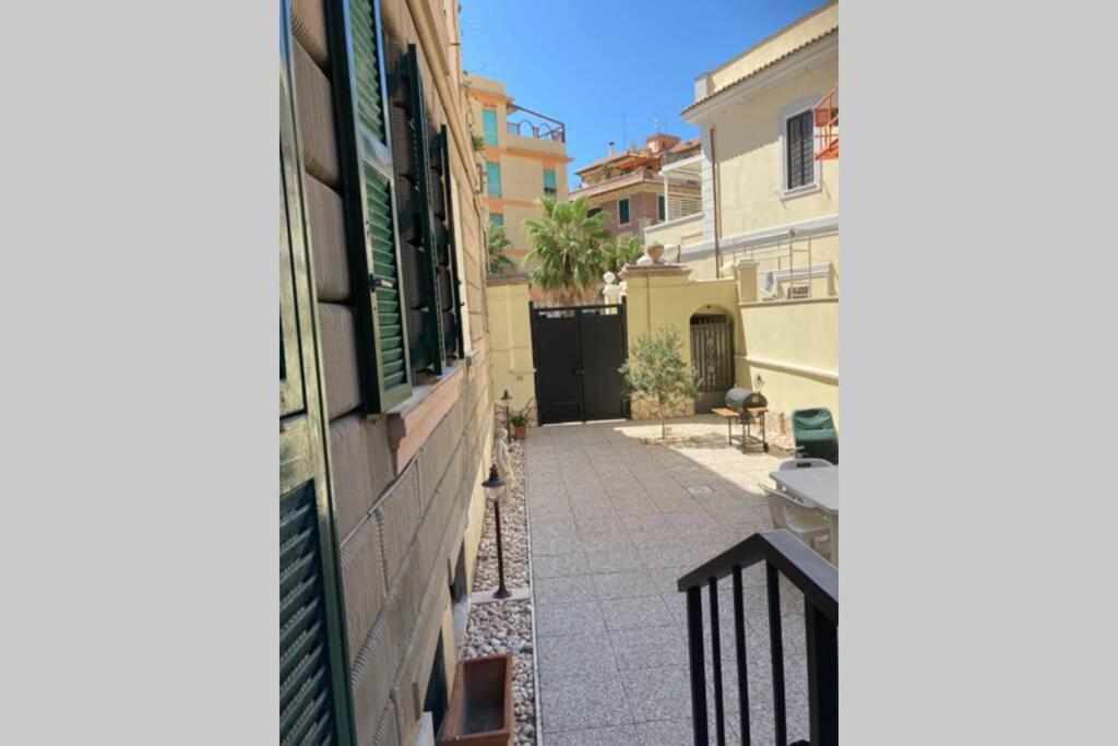 a view of an alley between two buildings at Piazza Anco Marzio fronte mare casa con giardino in Lido di Ostia