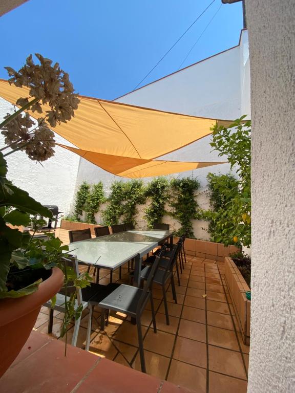 un patio con mesa y sillas debajo de una tienda de campaña en Cal Gerani, en Rabós