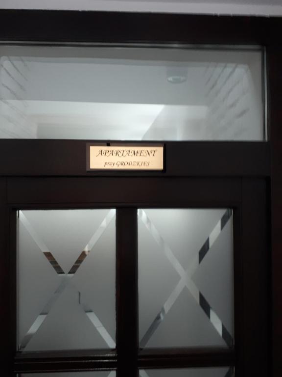 a sign on top of a glass door at Głogów przy Grodzkiej in Głogów
