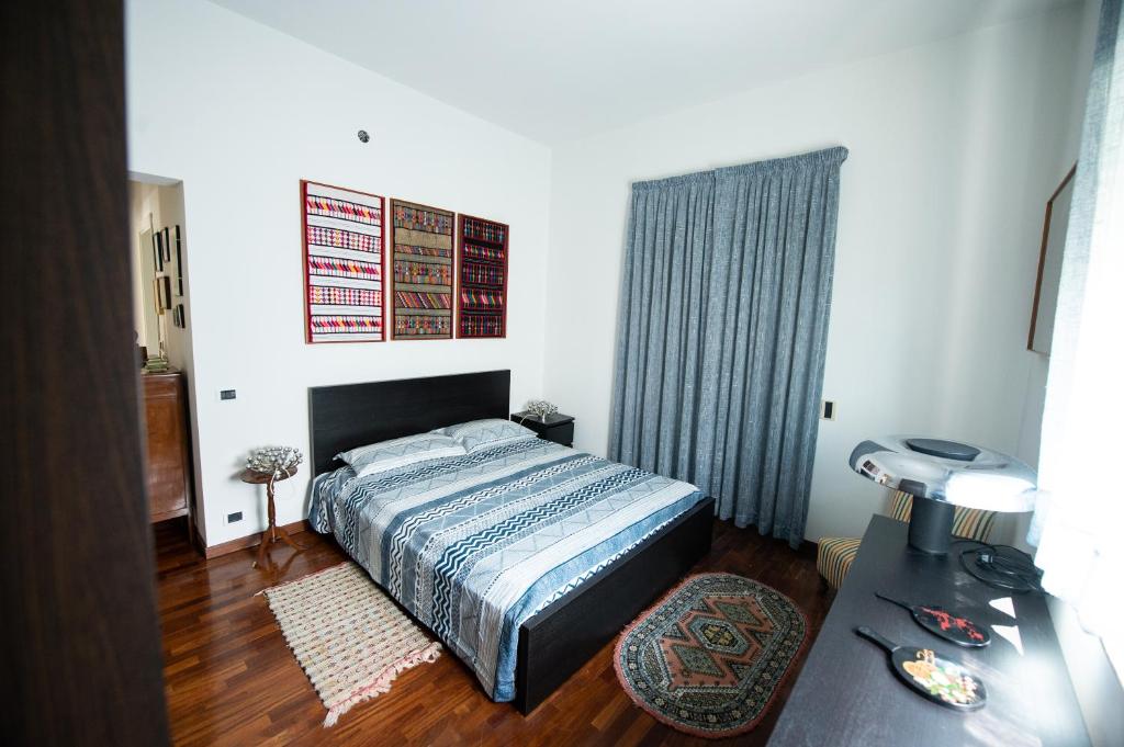 een slaapkamer met een bed en een tafel met een lamp bij CASA LIBERTINI in Grammichele