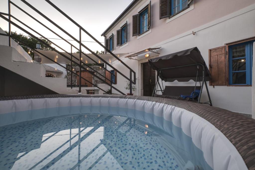 a swimming pool in front of a building at Kuća za odmor Tonka in Grižane