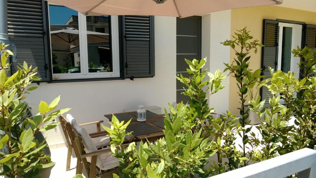 a patio with a table and chairs and an umbrella at Terra di Sicilia in Avola