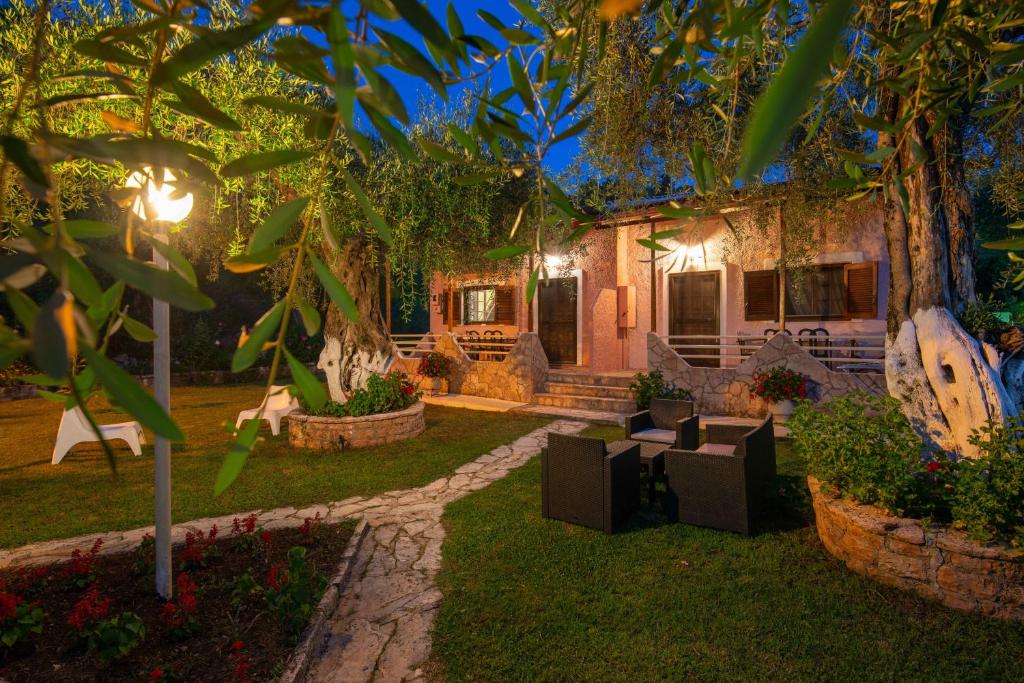 a house with a garden at night at Anneta Studios in Sivota