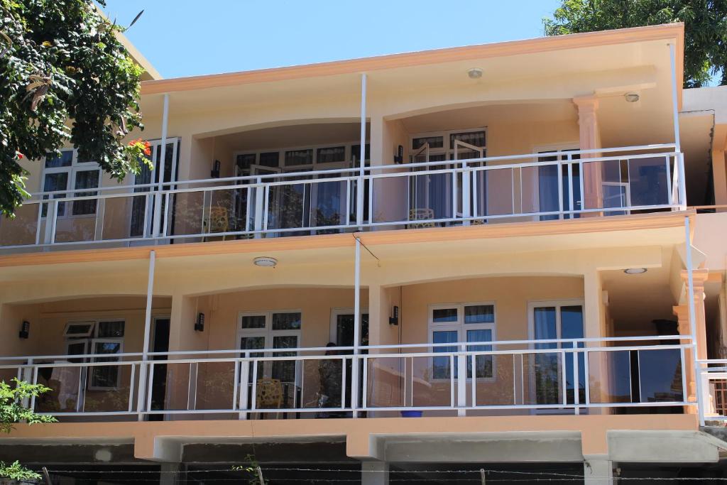 a building with balconies on the side of it at Bano Beach Residence - Grand Bay Beach in Grand-Baie
