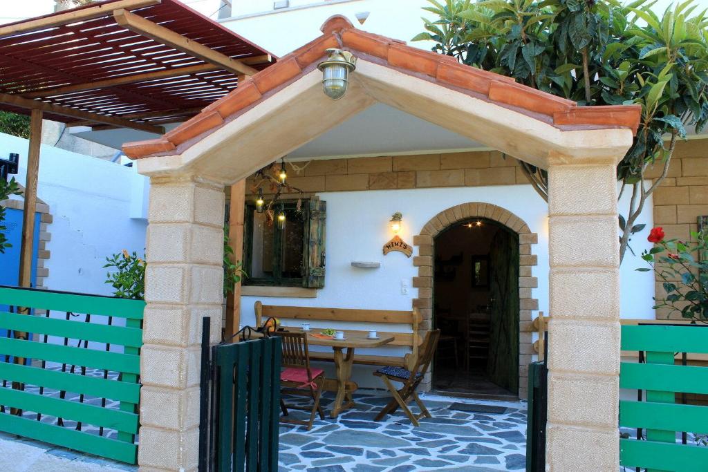 an outdoor patio with a table and awning at Village Villa Marika - Mimis Drapanias in Drapaniás