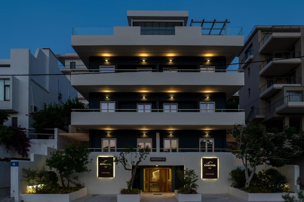a large white building with lights on it at CHROMA Lodge Rafina in Rafina
