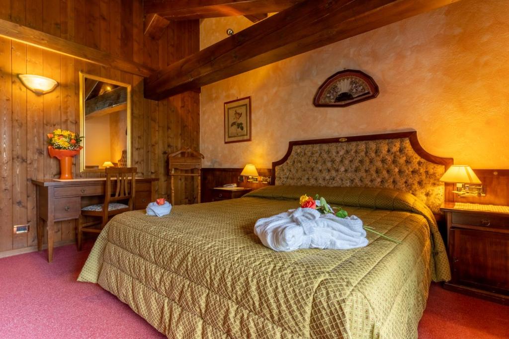 Posteľ alebo postele v izbe v ubytovaní Hotel Des Alpes