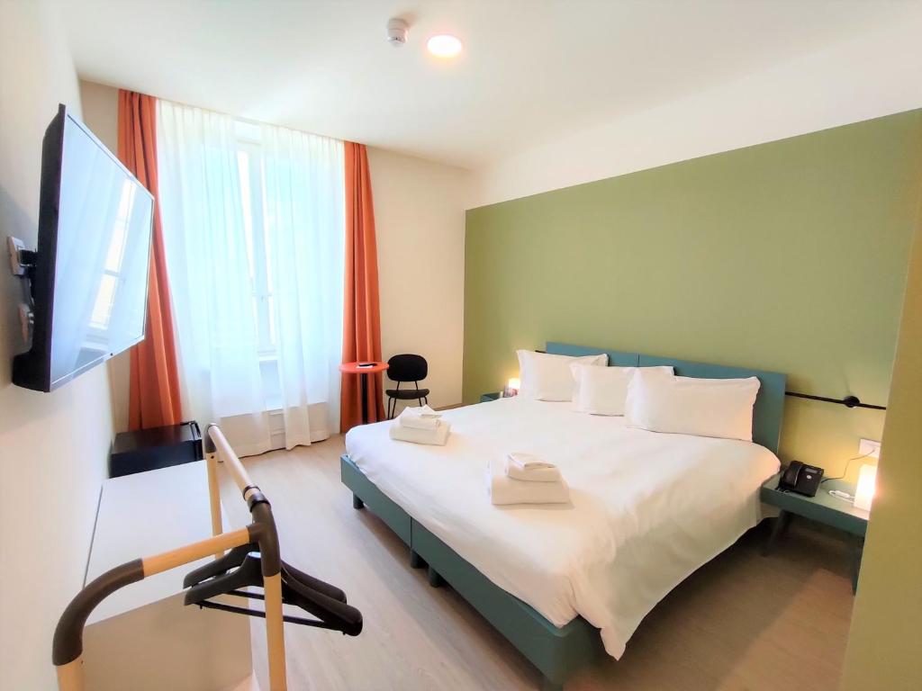 a bedroom with a bed and a flat screen tv at Camplus Guest Bernini Casa per Ferie in Turin