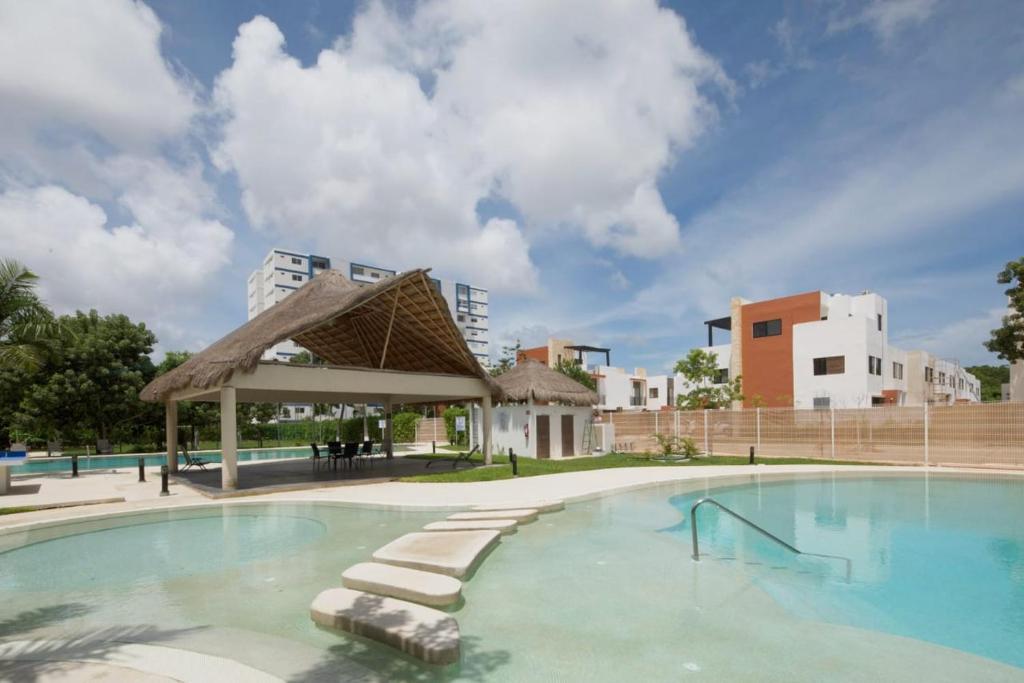 a large swimming pool with a gazebo at Liverte Cancún downtown in Cancún