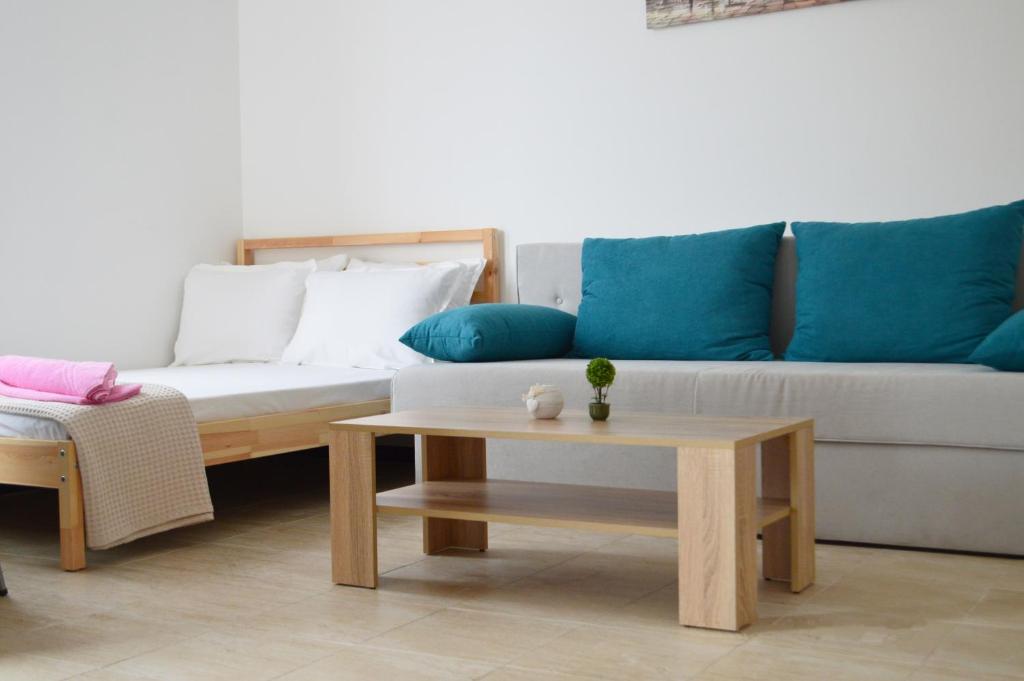 a living room with a couch and a coffee table at Aquamarine Apartments in Sveti Vlas