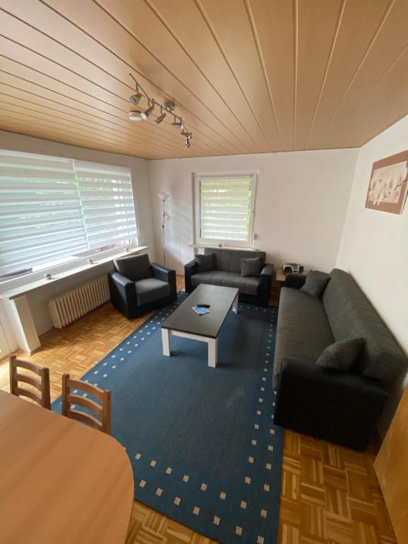 a living room with two couches and a table at Ferienwohnung Schmidt in Braunlage
