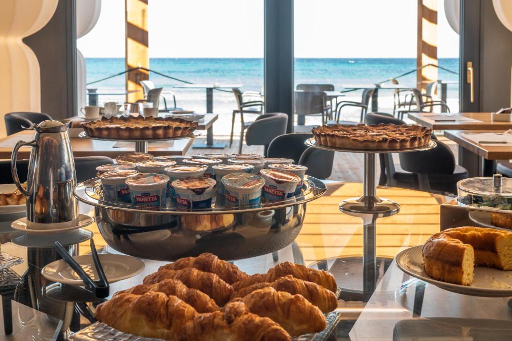 a buffet with various pastries and desserts on display at Hotel Punta Tipa in Trapani