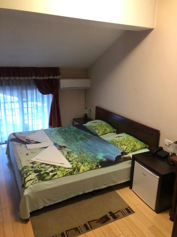 a bedroom with two beds in a room with a window at Hotel Royal in Bijelo Polje