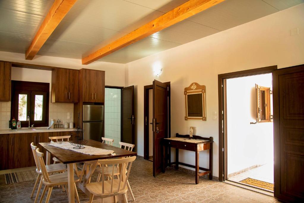 a kitchen with a table and chairs in a room at flamingo colour valey house in Palekastron