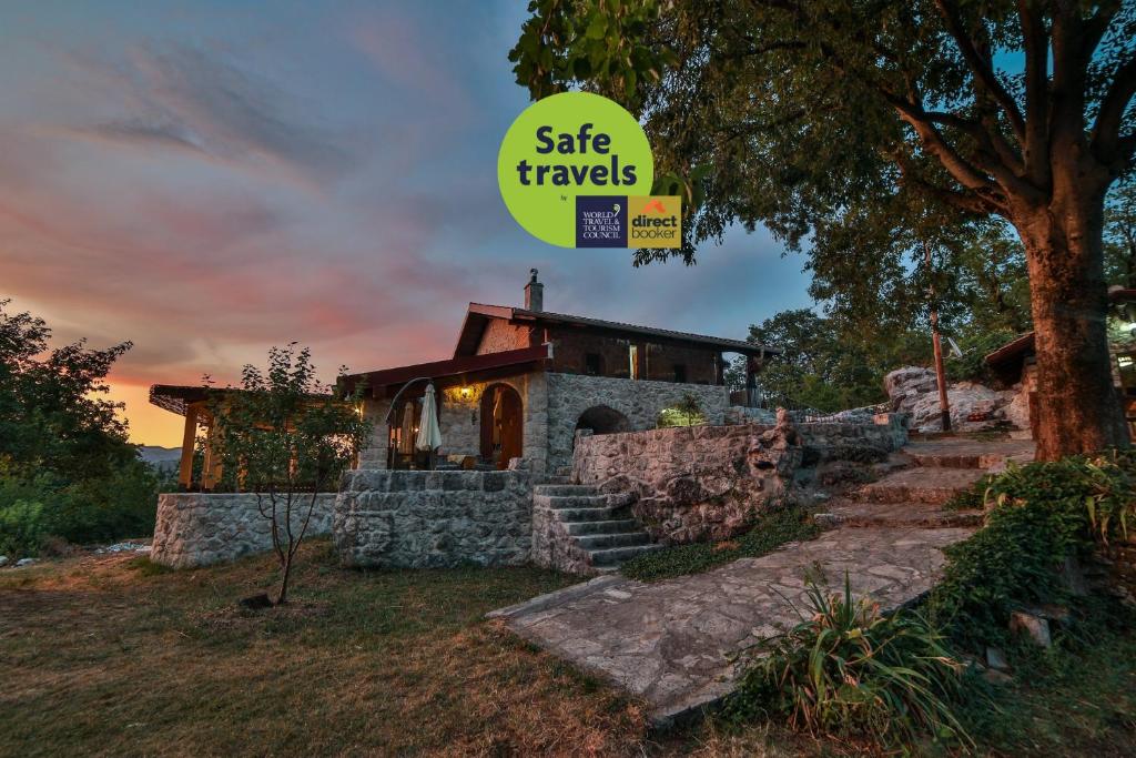 a stone house with a sign that reads safe travels at Royal Villa Ana in Cetinje