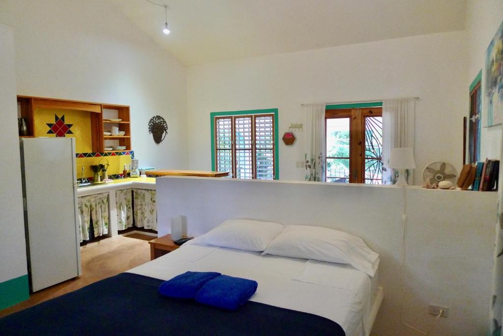 a bedroom with a bed with two blue pillows on it at Apart-Hotel Garden Villa in Las Galeras
