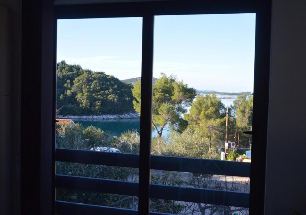 a view of a lake from a window at Island Residence in Sali