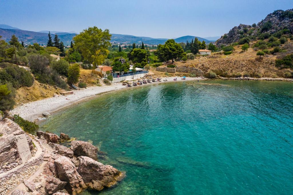 a beach with a group of people in the water at XeniCamp-Retreat in Nafplio