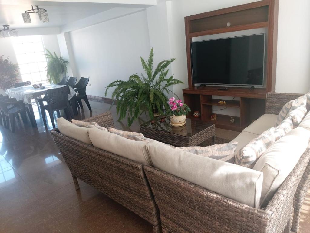 sala de estar con sofá y TV de pantalla plana en Apartamento Familiar Cusco, en Cusco