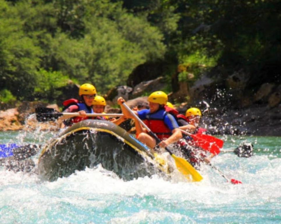 a group of people on a raft in the water at Camp Rafting Apartmani in Žabljak