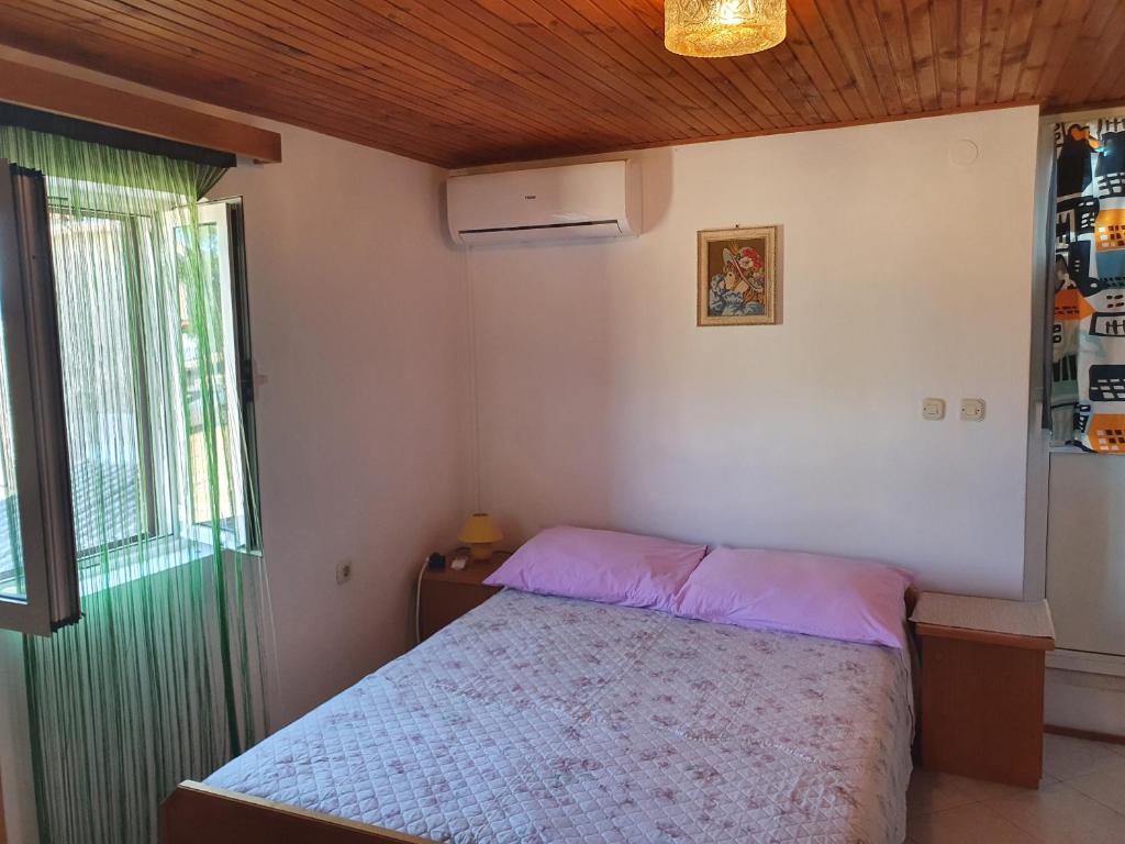 Postel nebo postele na pokoji v ubytování Apartman Letizia