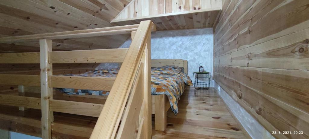 a bedroom with two bunk beds in a log cabin at Apartmani Vuk in Kolašin