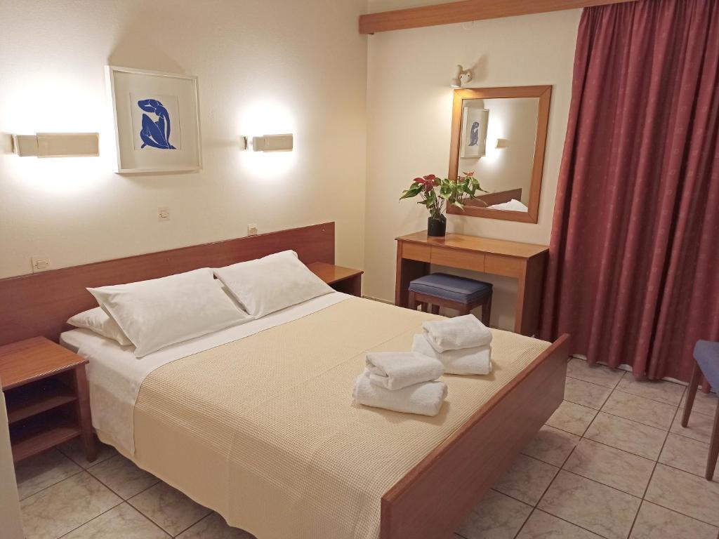 Postel nebo postele na pokoji v ubytování Dioni Hotel