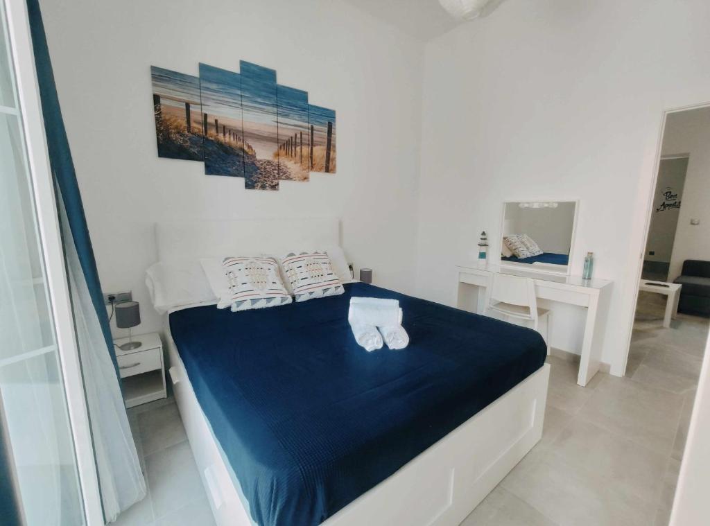 a bedroom with a bed with blue sheets and pillows at Sunlight Málaga Centro in Málaga