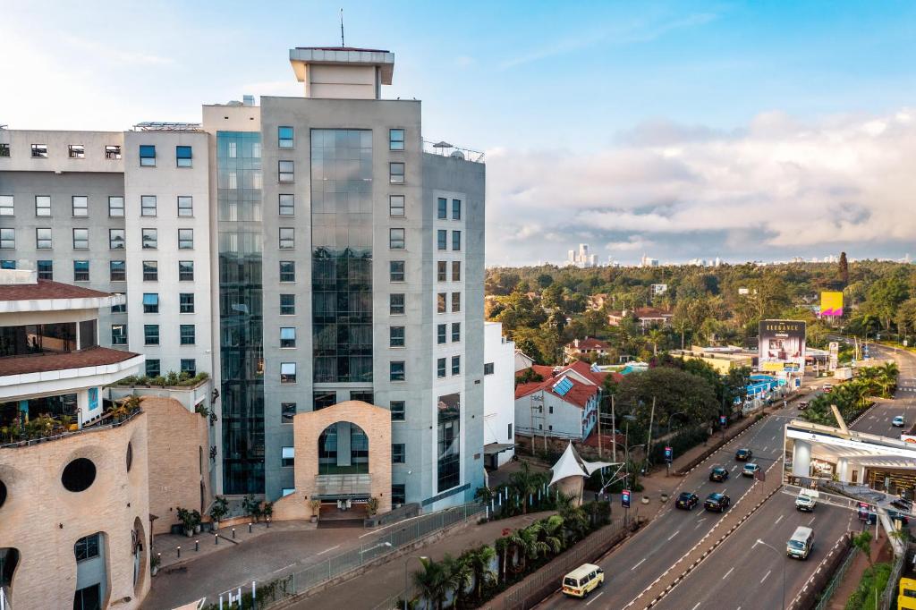 a tall white building on a city street at Trademark Hotel, a Member of Design Hotels in Nairobi