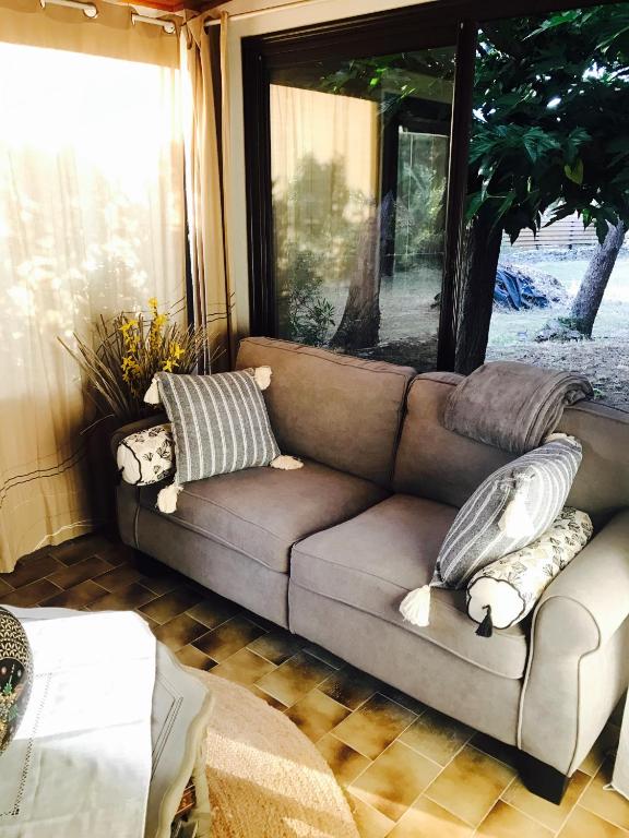 a couch in a living room with pillows on it at VILLA EDEN in Figari