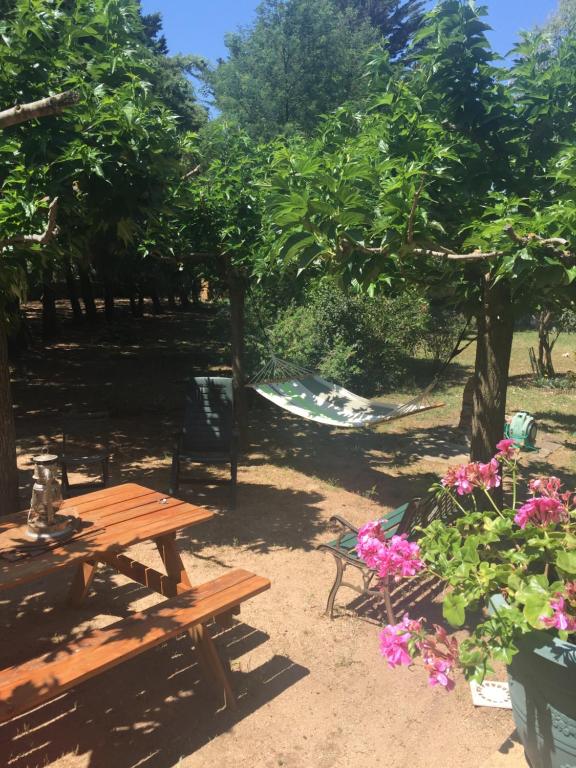 a picnic table and chairs in a park with flowers at VILLA EDEN in Figari