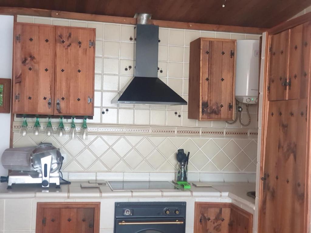a kitchen with wooden cabinets and a stove at CASA SARA in Parque Holandes