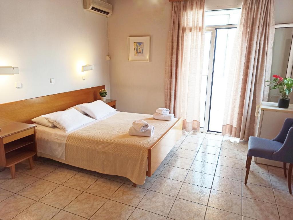 Postel nebo postele na pokoji v ubytování Dioni Hotel