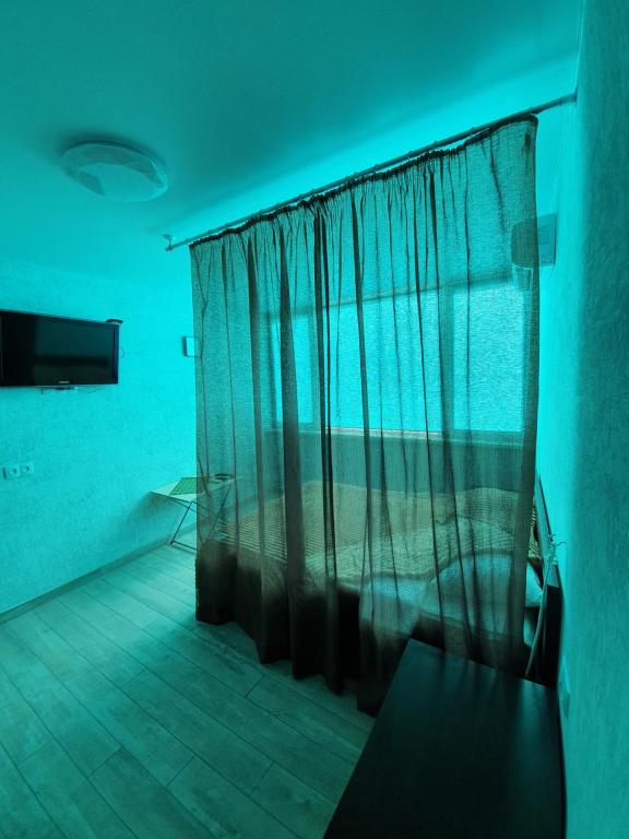 a bedroom with a bed with a curtain in a room at Silver 2 Затока in Zatoka