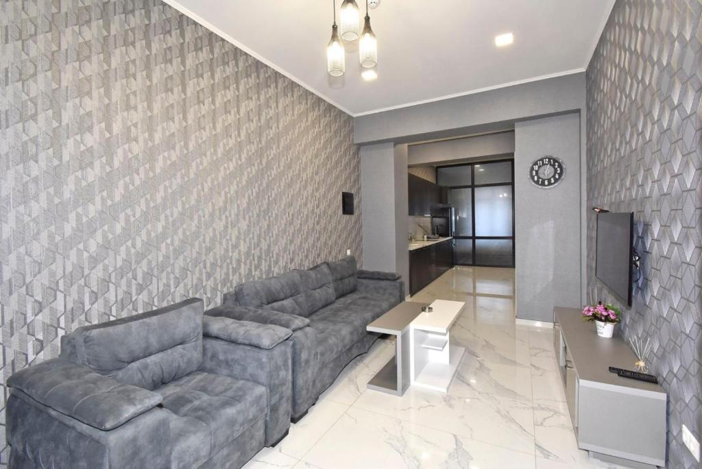 a living room with a couch and a tv at Teryan street,1 bedroom Modern, New Eurorenovated apartment TT881 in Yerevan