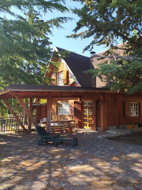 a house with a chair in front of it at Chalet in legno in Campo di Giove