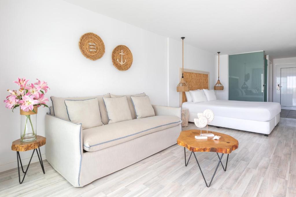 a living room with a couch and a bed at Blue Harbour Boutique in Ayia Napa