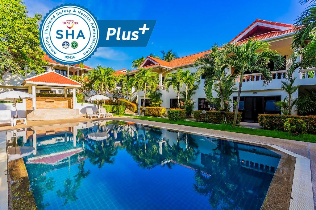 ein Pool vor einem Hotel mit dem Shka-Schild in der Unterkunft Phuket Riviera Villas - SHA Extra Plus in Nai Harn Beach