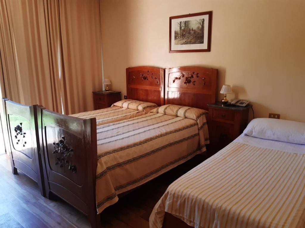 Postel nebo postele na pokoji v ubytování Relais Leon d'Oro