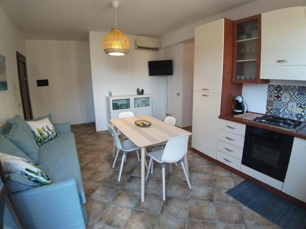 a kitchen and dining room with a table and chairs at IL VIAGGIO DI COSIMO in San Vito lo Capo