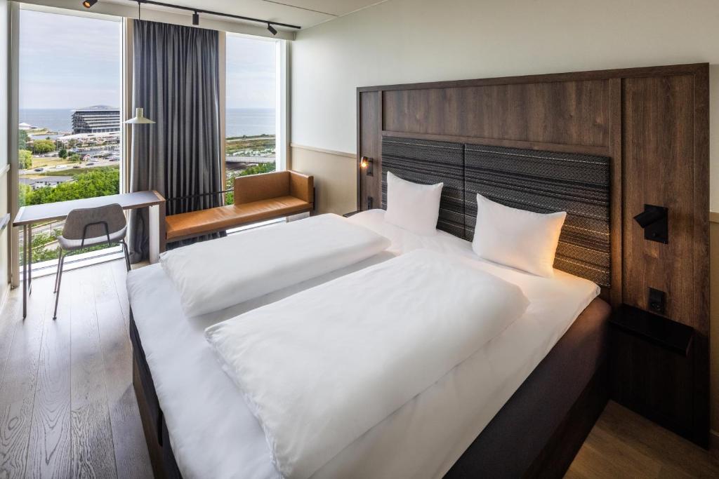 a hotel room with a large bed and a window at Comfort Hotel Copenhagen Airport in Copenhagen
