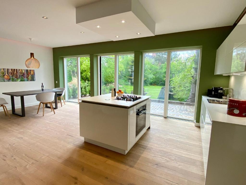 a kitchen with an island in the middle of a room at “STADT-LAND-SCHEUNE” - luxuriös in alten Gemäuern in Braunschweig