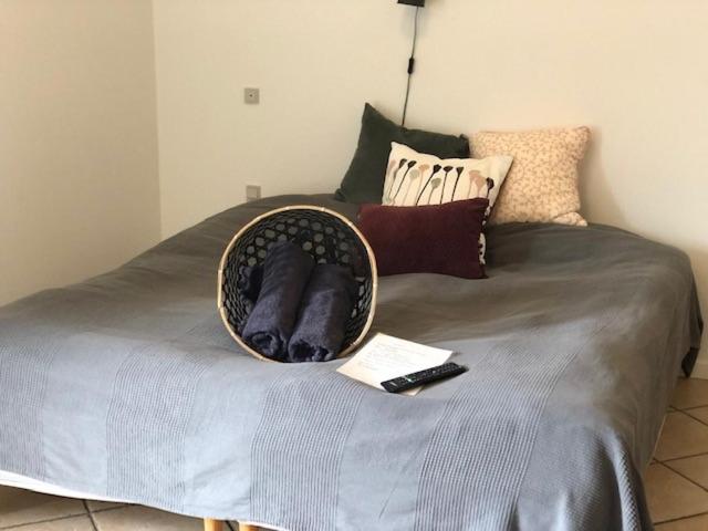 a basket on top of a bed with a remote control at Allesø Gl. sognefoged gård in Odense