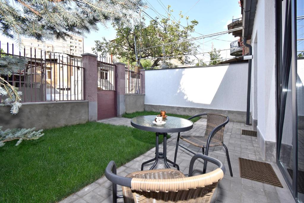 a small patio with a table and chairs on a balcony at The Nut Guest House in Yerevan