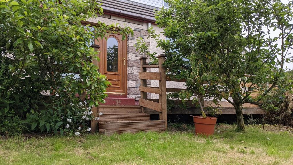 a small house with a bench in the yard at Remuera, North Tolsta in North Tolsta