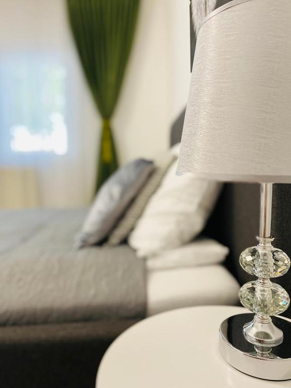 a lamp on a table next to a couch at AV Apartment in Turda
