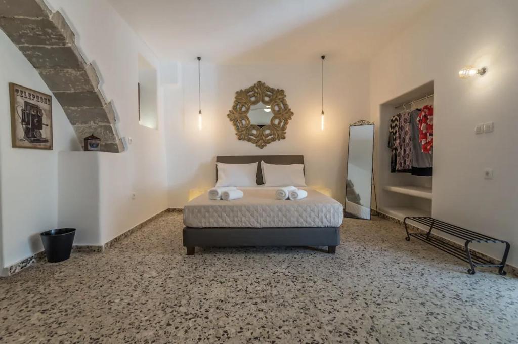a bedroom with a bed and a mirror on the wall at Sunset Studio in Plaka Milou
