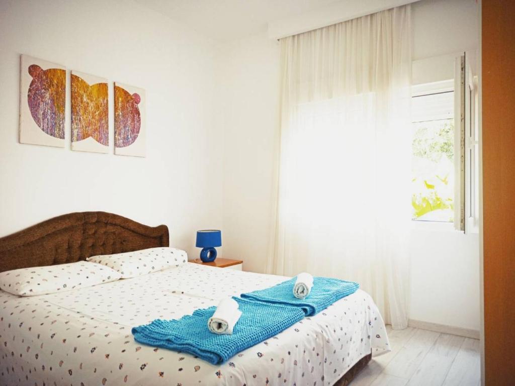 a bedroom with a bed with two towels on it at Mediteraneo Apartments in Budva